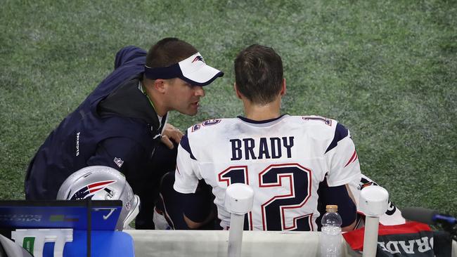 Offensive coordinator Josh McDaniels talks to Tom Brady. Picture: Getty