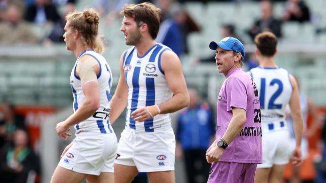 A North Melbourne runner delivers a message to player. Picture: Michael Klein