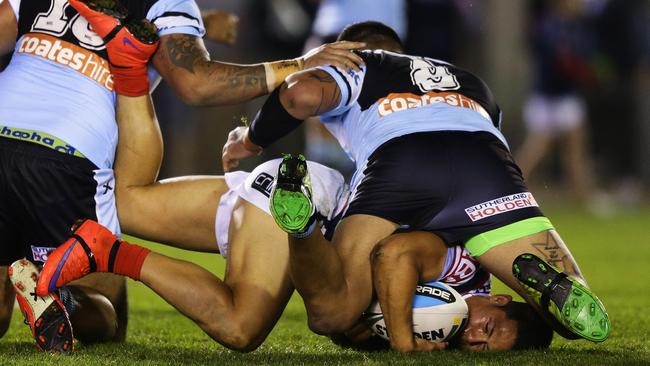 Rooster Roger Tuivasa-Sheck is ground into the turf against the Sharks. Picture: Brett Costello