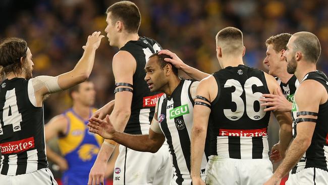 Teammates swamped Travis Varcoe after his stunning goal to open the Pies’ account. Pictue: Getty Images