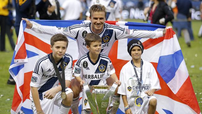 David Beckham with his sons Brooklyn, Romeo and Cruz in 2012. Picture: AP Photo/Jae C. Hong