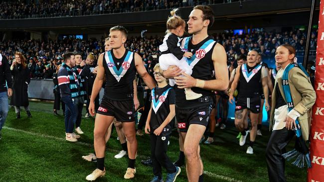 Jeremy Finlayson and his daughter runs out for his 100th game in Round 17. Picture: Mark Brake/Getty Images