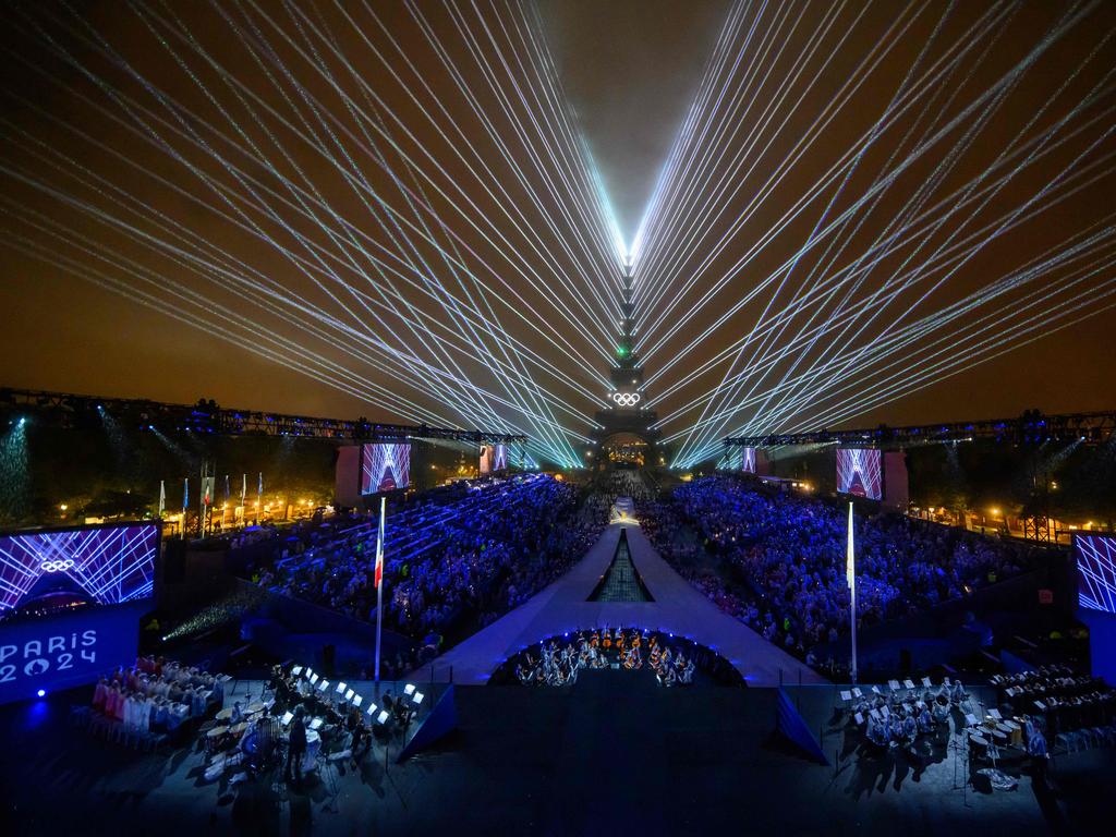 Overview of the Trocadero venue, with the Eiffel Tower looming in the background and lasers lighting up the sky, during the opening ceremony of the Paris 2024 Olympic Games on July 26, 2024 (Photo by FranÃ§ois-Xavier MARIT / AFP)