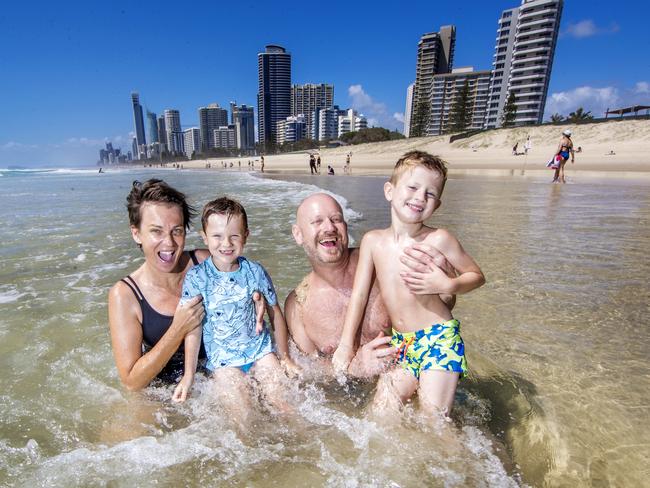 Fiona and Rob Hagen of Melbourne frolic on the Gold Coast with sons Max (left), 6, and Harry, 5. Picture: Nigel Hallett