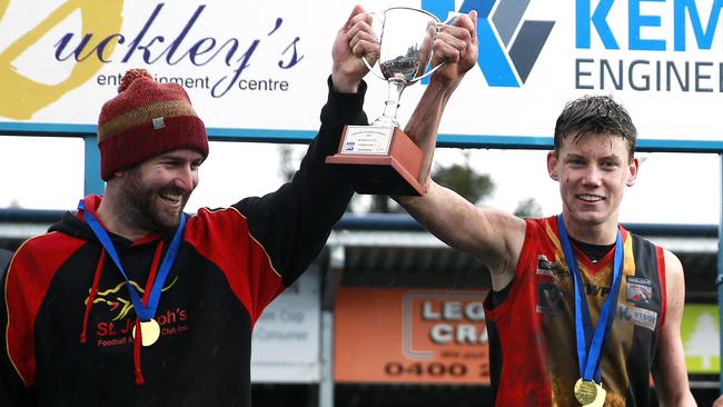 St Joseph’s coach Michael King and captain Sam Walsh celebrate their under-16 premiership in 2016. Picture: Alison Wynd