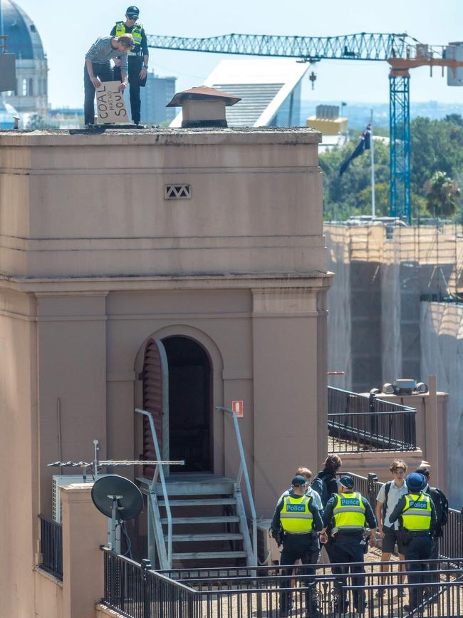 Police remove the students. Picture: Jason Edwards