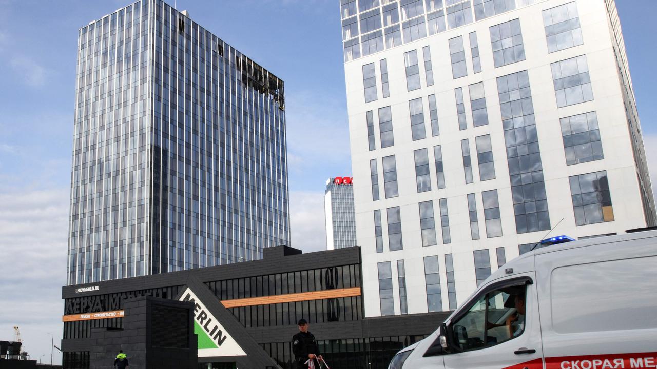 An ambulance drives in front of a damaged business centre on Likhacheva Street after a reported drone attack in Moscow on July 24, 2023. Picture: AFP