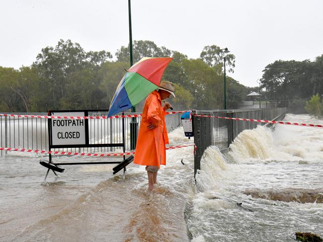 Monday February 3. heavy rain lashes Townsville.  Ian McCubben checks the water flow at Aplins Weir. Picture: Evan Morgan