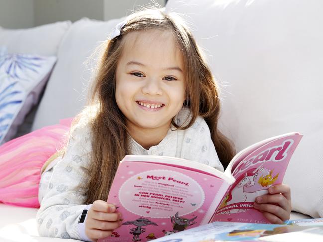 WEEKEND TELEGRAPHS SPECIAL. MUST TALK WITH PIC ED JEFF DARMANIN BEFORE PUBLISHING - Pictured is Sienna Lee 6, reading books for a story on how important reading is to mark the start of Book Week on Saturday. Picture: Tim Hunter.