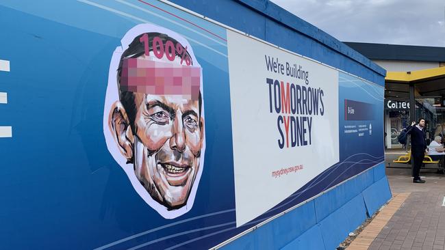 An offensive sign featuring the face of Tony Abbott and the c-word. Picture: Tim Hunter