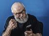 Old man angry at phone. Stock image from istock