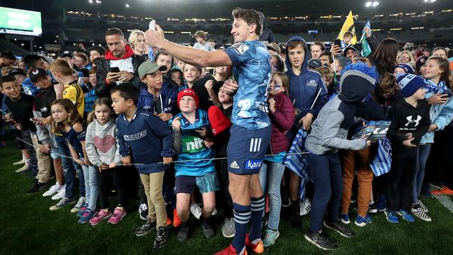 Beauden Barrett of the Blues signs autographs and poses for photos after the Round 1 Super Rugby Aotearoa match against the Hurricanes at Eden Park. Picture: Getty Images