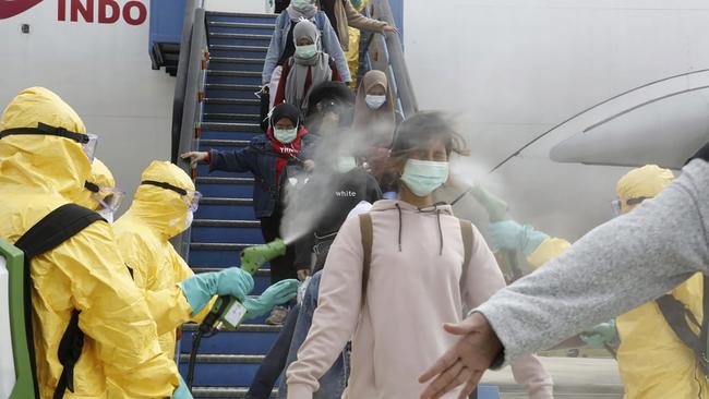 Passengers arriving from Wuhan, China, are sprayed with antiseptic at Hang Nadim Airport in Batam, Indonesia on February 2.