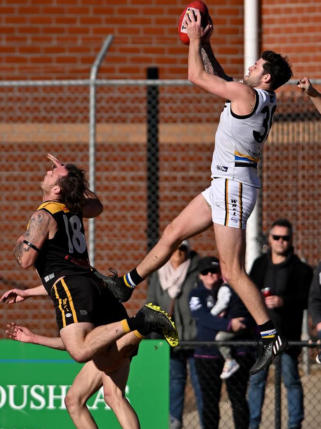 Caroline Springs’ William Young took this huge grab. Picture: Andy Brownbill