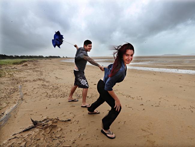 Daniel McDonald and Tammie Pattel battle the elements at Mackay beach. Picture: Annette Dew