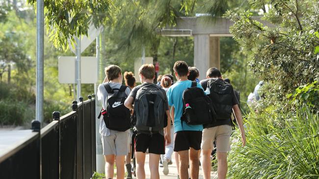 DAILY TELEGRAPH - Pictured are kids leaving Lindfield Learning Village today where Primary School classes are displaying student-made posters in emblazoned with the words ``stop killer cops" and "pigs out of the country". Picture: Tim Hunter.