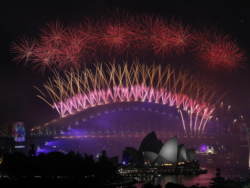 New Year's Eve 2018 - The midnight fireworks display over the Sydney Opera House and Sydney Harbour Bridge from a rooftop in Potts Point. Picture: Toby Zerna