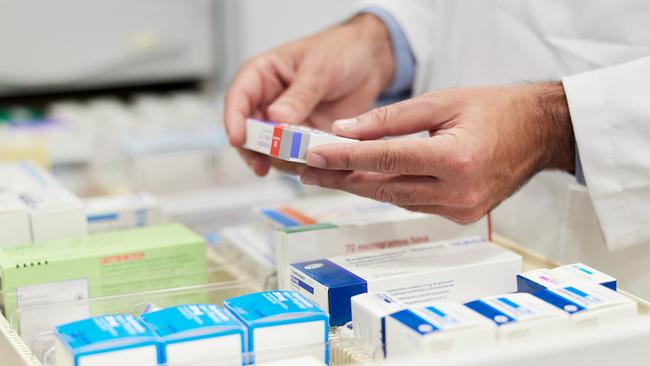 Cloe-up view of a pharmacist hands holding merchandise.