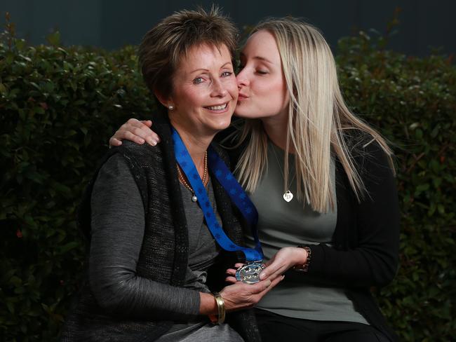 Wendy Higgins gets a kiss from her daughter Sara, after accepting with her late husband Dean’s Pride of Australia aware on his behalf. Picture Dylan Coker