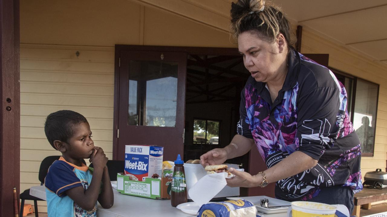 Nikita Sellin serves a free cooked breakfast to a child. Picture: Brian Cassey