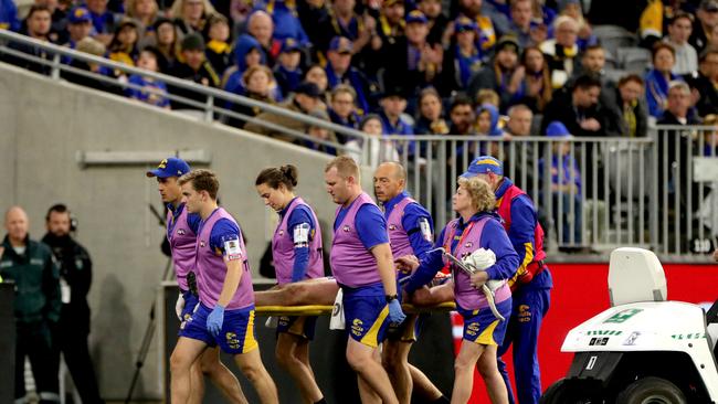 Venables is stretchered from the ground — the last time he would ever play an AFL game. Picture: AAP