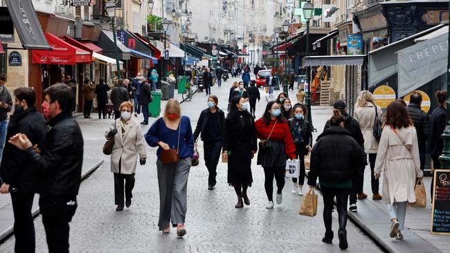 Pedestrians, wearing face masks, walk in the Montorgueil district in Paris. Picture: AFP