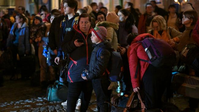 People, mainly women and children, board coaches at Poland’s Przemysl station as they continue their onward journey from war-torn Ukraine. Picture: Getty Images