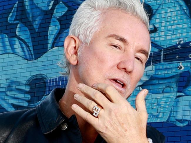 BURLEIGH HEADS GOLD COAST , AUSTRALIA - June 4 2022, Film Director Baz Luhrmann poses for a photo in front of the giant Elvis Presley TCB mural at Burleigh HeadsPicture Scott Powick Newscorp.