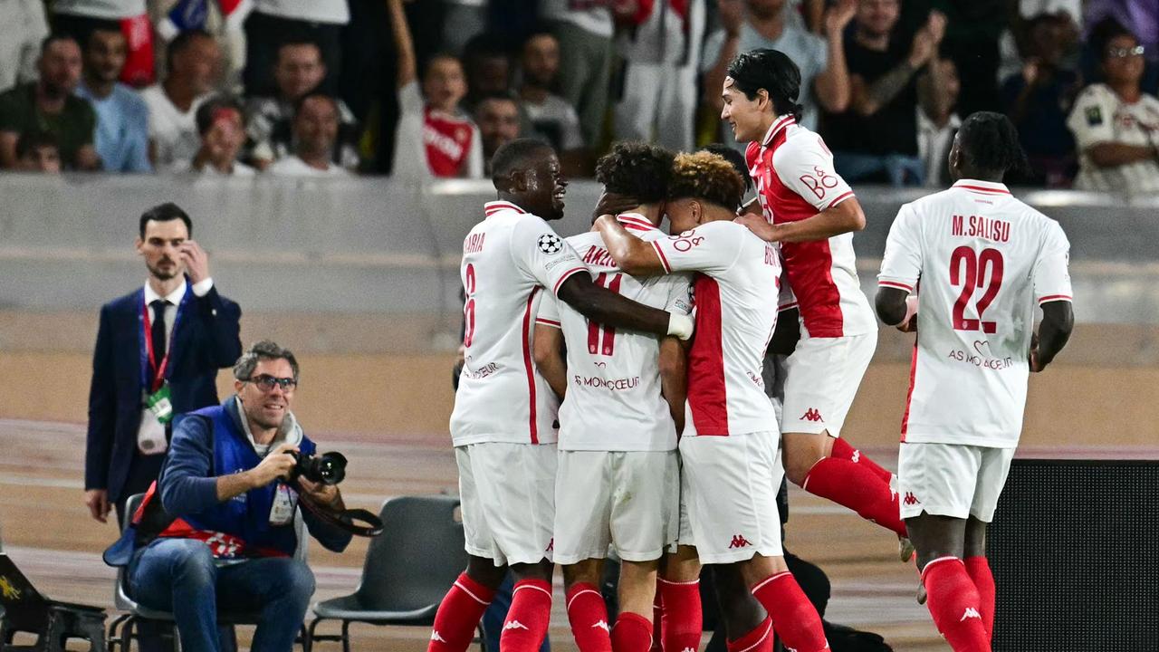 Monaco's French midfielder Maghnes Akliouche celebrates with teammates. Photo by Miguel MEDINA / AFP