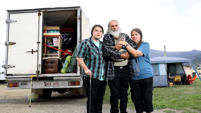 The Reid family, James, 23, left, Michael, 57, holding Rolland the cat, and Kathy, 47, who have recently moved to Tasmania from Cairns. They can't find a rental property and are living in a tent at the Showgrounds. Picture: SAM ROSEWARNE