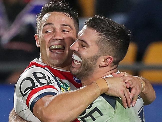 James Tedesco of the Roosters (right) is congratulated by teammate Cooper Cronk after scoring a try during the Round 10 NRL match between the Warriors and the Sydney Roosters at Mt Smart Stadium in Auckland, New Zealand, Saturday, May 12, 2018. (AAP Image/David Rowland) NO ARCHIVING, EDITORIAL USE ONLY