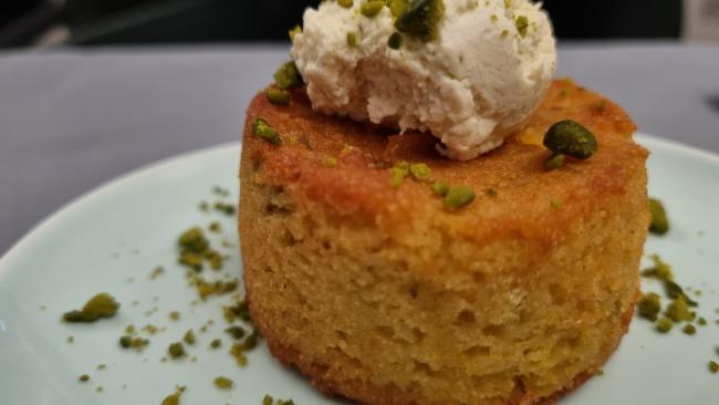 Persian orange polenta cake with pistachio, rosemary, and honey cream. Picture: Kirrily Schwarz