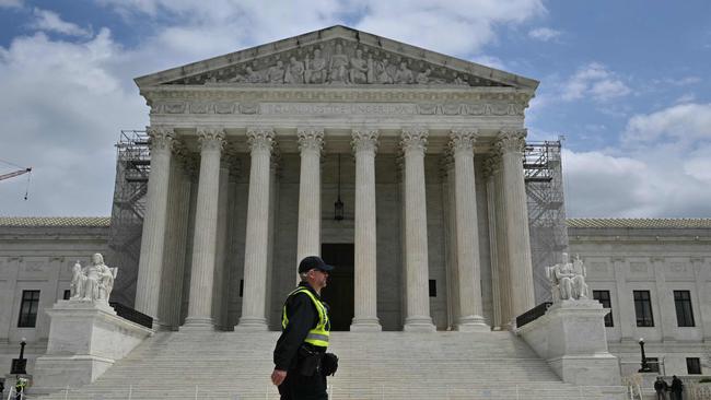 A police officer walks on the plaza of the US Supreme Court. Picture: AFP