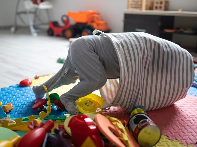 Little boy trying to hide in laundry basket at home