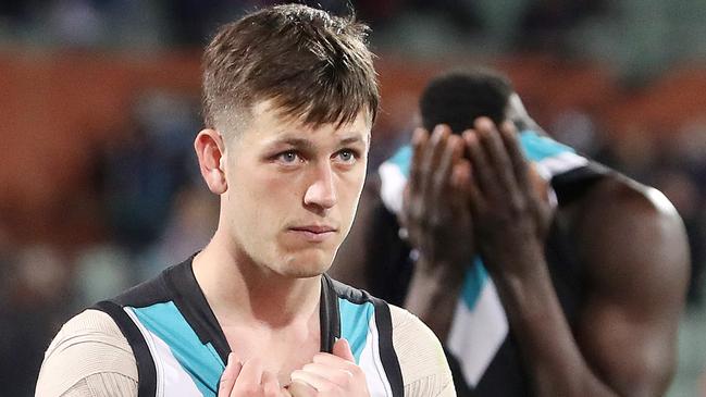 ADELAIDE, AUSTRALIA - SEPTEMBER 11: Zak Butters of the Power with Aliir Aliir in the background after the loss during the 2021 AFL Second Preliminary Final match between the Port Adelaide Power and the Western Bulldogs at Adelaide Oval on September 11, 2021 in Adelaide, Australia. (Photo by Sarah Reed/AFL Photos via Getty Images)