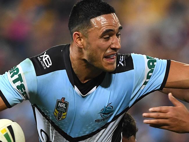 Valentine Holmes of the Sharks fends off Anthony Milford of the Broncos during the Round 20 NRL match between the Brisbane Broncos and the Cronulla-Sutherland Sharks at Suncorp Stadium in Brisbane, Thursday, July 26, 2018. (AAP Image/Dave Hunt) NO ARCHIVING, EDITORIAL USE ONLY