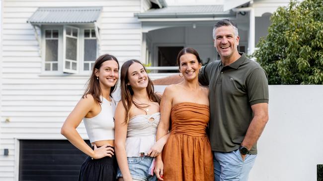 Dennis with wife Mia, daughters Poppy, 13, and Matilda, 17, in front of their original Queenslander and of course, Betty. Picture by Luke Marsden.