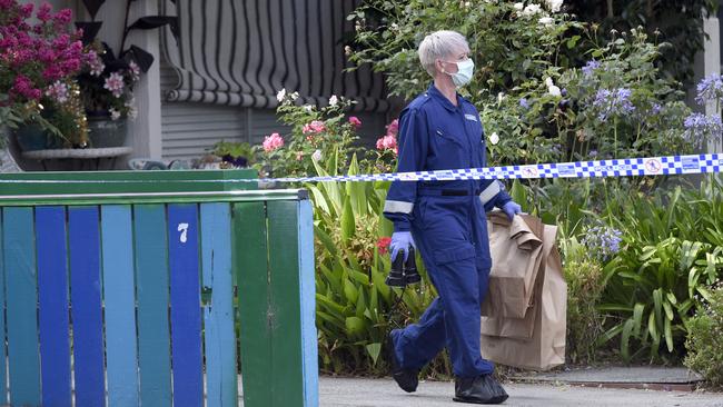 Forensic officers remove items from the scene. Picture: Andrew Henshaw