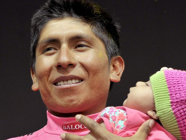 Colombia's Nairo Quintana holds her daughter Mariana as he stands on the podium after winning the Giro D'italia, Tour of Italy cycling race, in Trieste, Italy, Sunday, June 1, 2014. Nairo Quintana confirmed himself as cycling's next star by winning the Giro d'Italia on Sunday to follow his runner-up finish in last year's Tour de France. The 24-year-old climbing specialist with the Movistar team won two stages and finished with a 3 minute, 7 second advantage over fellow Colombian Rigoberto Uran for his first Grand Tour victory. Italy's Fabio Aru finished third overall, 4:04 back. (AP Photo/MArco Alpozzi)