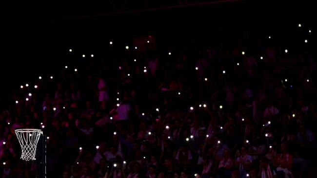 Fans hold torches as a power cut affects parts of the stadium during the match between the Thunderbirds and the Swifts. (Photo by Graham Denholm/Getty Images)