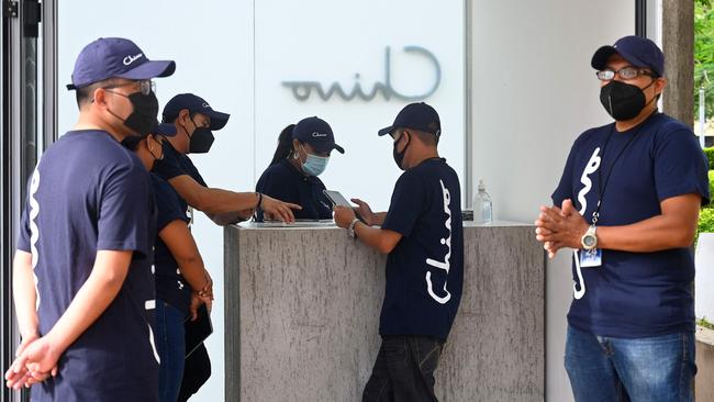 Government employees prepare to receive people who want to use a bitcoin ATM. Picture: AFP