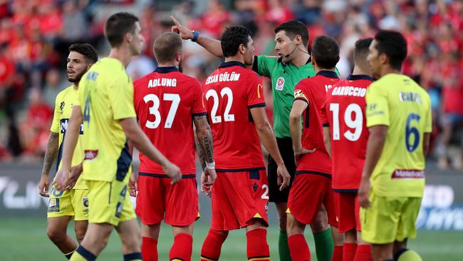 Ersan Gulum of United argues with the referee about the red card for this tackle on Trent Buhagiar of the Mariners during the Round 20 A-League match between Adelaide United and the Central Coast Mariners at Coopers Stadium. Picture: AAP Image/James Eslby