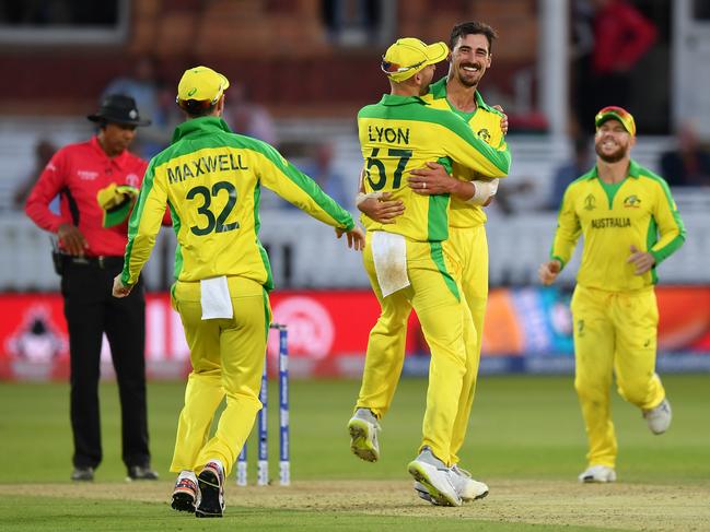 Glenn Maxwell, Nathan Lyon and David Warner rush to congratulate teammate Mitchell Starc of Australia after he dismissed Mitchell Santner of New Zealand to give him his 5th wicket of the match. Picture: Getty