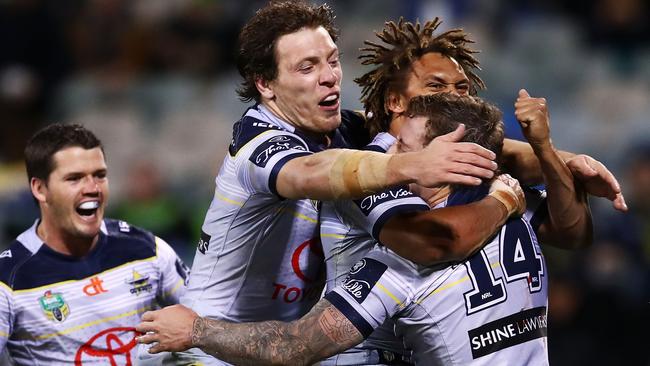 Josh Chudleigh celebrates a try with Cowboys teammates.