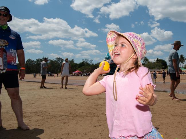 Ayla Stephens playing throw it in the hole and win your self a prize at the Darwin Beer Can Regatta at Mindil Beach, 2024. Picture: Pema Tamang Pakhrin
