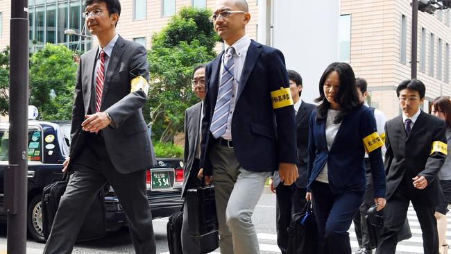Officials from the Tokyo Labor Bureau. Picture: Akiko Matsushita/Kyodo News/AP