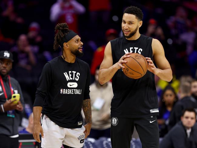 PHILADELPHIA, PENNSYLVANIA - MARCH 10:  Patty Mills #8 and Ben Simmons #10 of the Brooklyn Nets take the court for warm ups before the game against the Philadelphia 76ers at Wells Fargo Center on March 10, 2022 in Philadelphia, Pennsylvania. NOTE TO USER: User expressly acknowledges and agrees that, by downloading and or using this photograph, User is consenting to the terms and conditions of the Getty Images License Agreement. (Photo by Elsa/Getty Images)