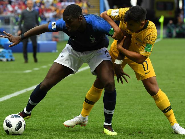 Daniel Arzani tangles with Manchester United and France star Paul Pogba.