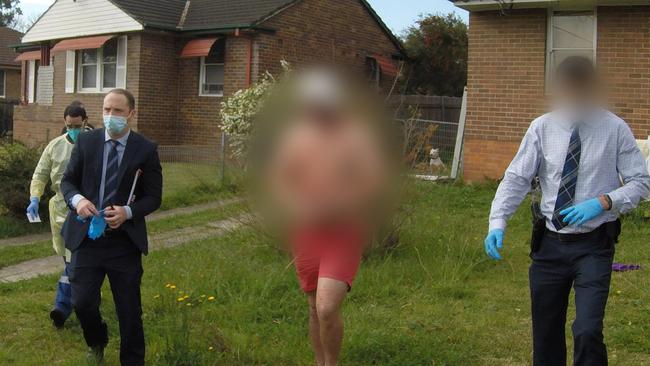 A 19-year-old man is lead out of a Wentworthville house by detectives on Wednesday after a raid. Picture: NSW Police