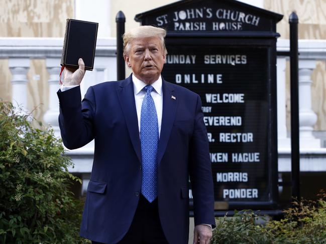 President Donald Trump holds a Bible as he visits outside St John's Church. Picture: AP